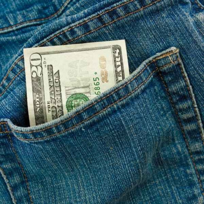 Closeup of twenty dollars in the back pocket of a pair of jeans